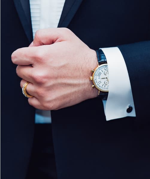 Joshua's watch and cufflink accessories in his blue wedding suit.